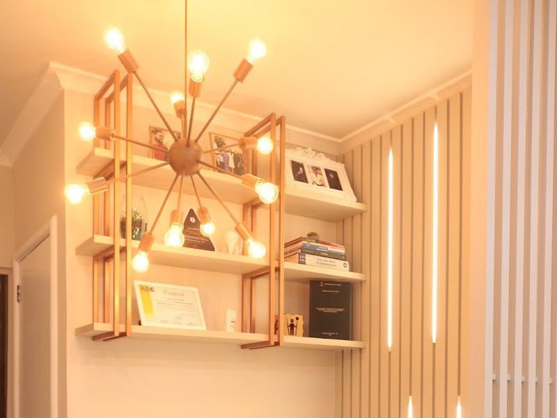 Ambiente interno do consultório ImplaOrto, com iluminação aconchegante e prateleiras com certificados